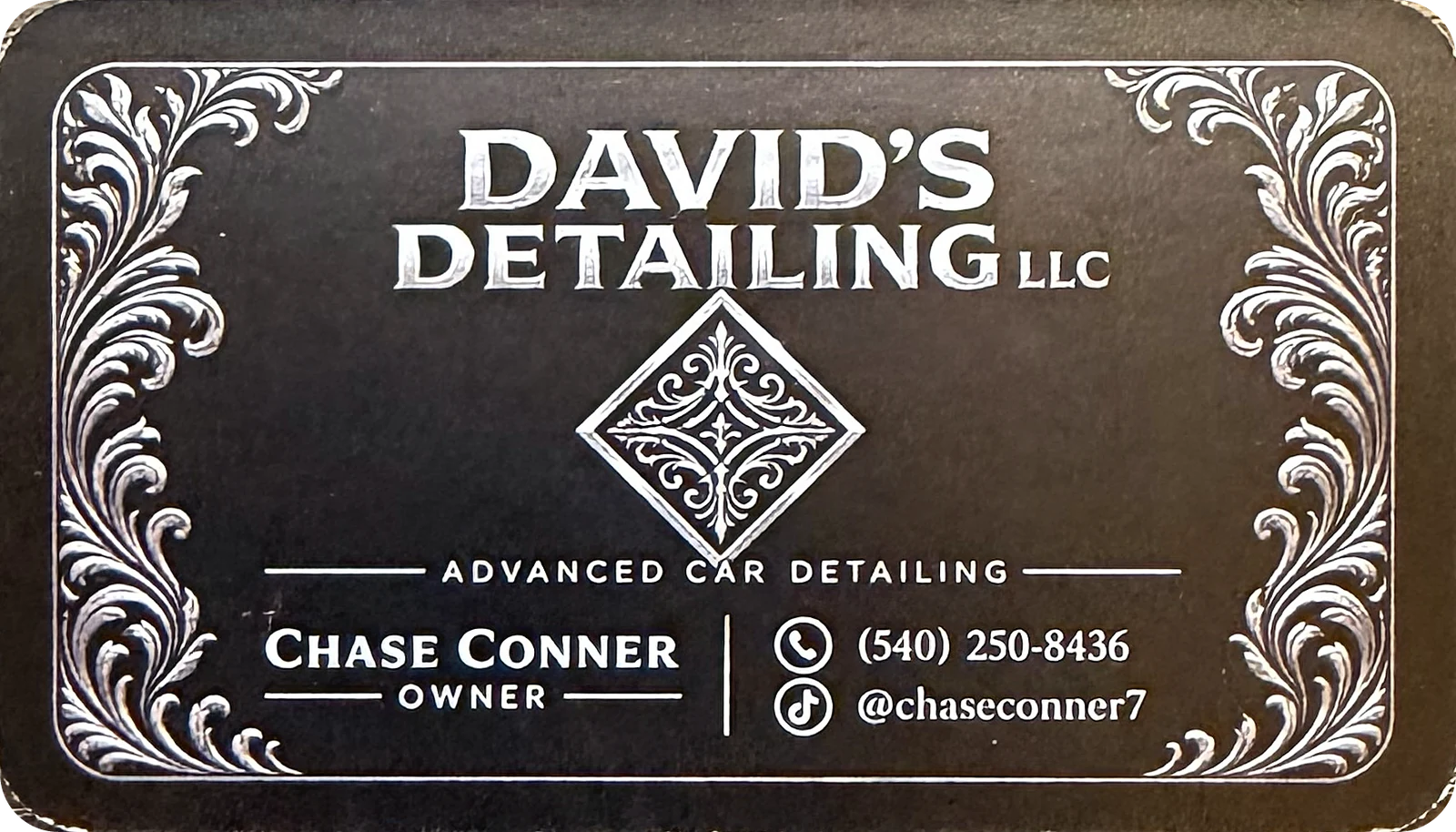 Printed David's Detailing LLC business card back with silver filigree borders, owner Chase Conner, phone number (540) 250-8436 and TikTok handle @chaseconner7
