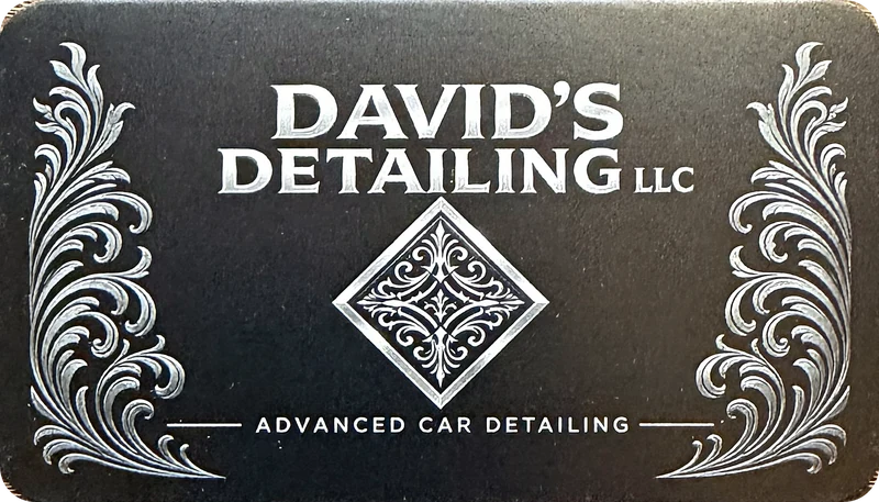 Printed David's Detailing LLC business card front with silver filigree scrollwork, a diamond emblem and the words Advanced Car Detailing on black card stock